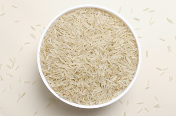 Raw basmati rice in a white bowl on a light background. Concept of Water-Conserving Products. Saving water. Vegetarian and vegan food. Healthy Eating. Horizontal orientation. Top view.
