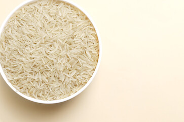 Raw basmati rice in a white bowl on a light background. Concept of Water-Conserving Products. Saving water. Dietary product. Healthy Eating. Horizontal orientation. Top view. Copy space.