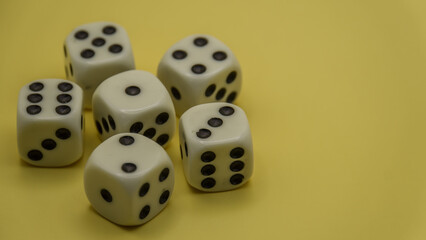 five dice cubes on a yellow background close up