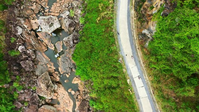 Drone, car and trees with road in forest for environment, countryside wildernesses and nature. Travel, river and valley with aerial view of Vietnam woodlands terrain for path, summer and highway