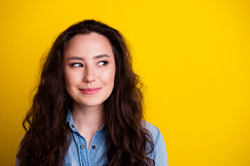 Portrait of pretty minded positive lovely lady look interested empty space isolated on yellow color background