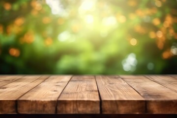 The empty wooden brown table top with blur background of a grean fild.