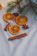 Fototapeta na wymiar Dried orange slices with cinnamon sticks and star anise on a white background
