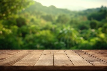 The empty wooden brown table top with blur background of a grean fild.