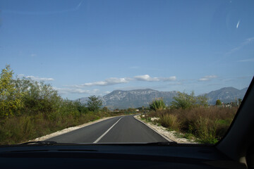 View of the road from inside the passenger seat of a car