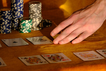 Playing Poker. Cards, chips in the sunny sunset light. Concept of sports board card games.