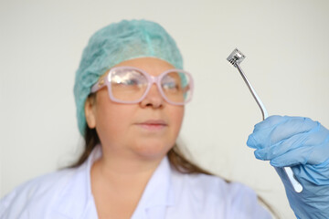 female scientist, doctor holding microprocessor, microchip, biochip with tweezers for...