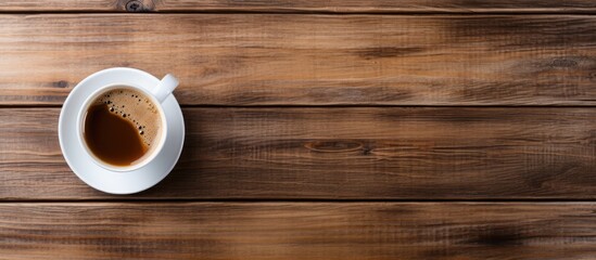 Top view of hot coffee in a white cup on a wooden table - Powered by Adobe