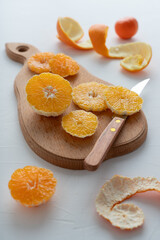 The process of making citrus jam. Orange and tangerine jam. Sliced fruits on a white background.