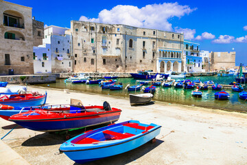 Traditional Italy - white town Monopoli with colorful fishinng boats in Puglia - 683411047