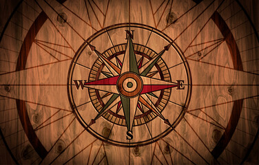 Wind rose compass engraved on wood background