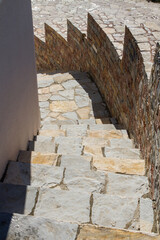Curved staircase with colored bricks along the edges