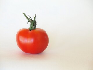 The red tomato on the white background