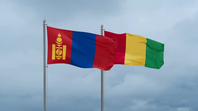 Republic of Guinea flag and Mongolia flag waving together on cloudy sky, endless seamless loop, two country relations concept