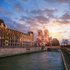 Notre-Dame in Paris and riverside on sunset
