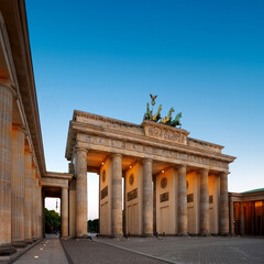 Brandenburg Gate in Berlin, Germany with illumination, copy-space on dark blue sky