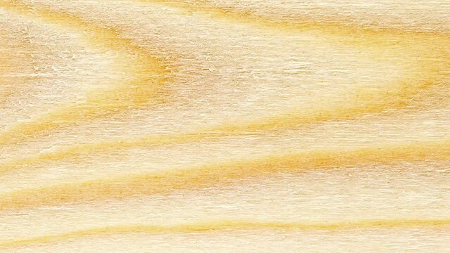 Wood, processed wooden yellow board, tree structure background, curved fibers, moving sideways, close-up macro