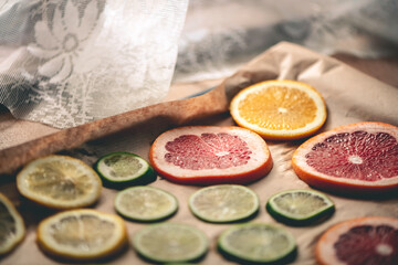 Sliced orange, tangerine and grapefruit slices on baking sheet, preparing citrus wedges for Christmas garland