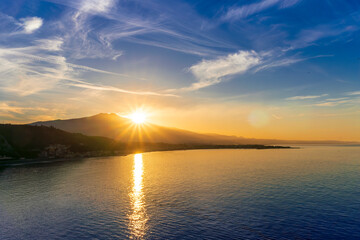 picturesque view to a sunset sea gulf with beautiful mountains and amazing cloudy sky on background of nice travel landscape