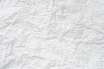 Wrinkled or crumpled white stencil paper or tissue after use in toilet or restroom with large copy space used for background texture in decorative art work