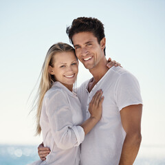 Couple, beach portrait and hug with love, support and care on a date by the sea with romance on vacation. Holiday, ocean and outdoor with summer travel in nature relax on a break and trip by water