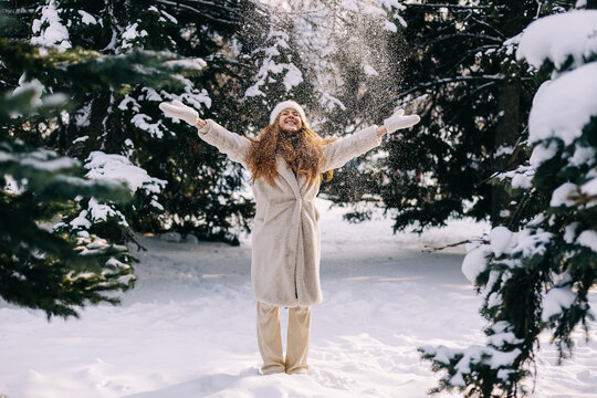 young woman enjoys cold winter day in the forest