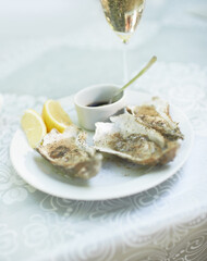 Background, food and plate of oysters with wine in restaurant for lunch, dinner and eating appetizer of gourmet cuisine. Closeup, luxury seafood diner and serving of shellfish on table with champagne