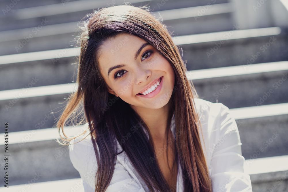 Poster portrait of cute peaceful young lady sitting stairs beaming smile good mood fresh air free time outd