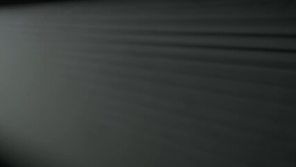 The effect of fog and haze on a black background illuminated by beams of light from a spotlight.