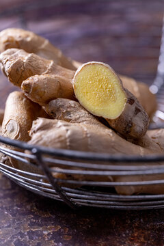 Root ginger in a round wire bowl, macro