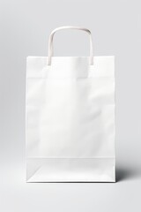 A white paper bag with a convenient handle on a plain gray background. This versatile image can be used to represent shopping, retail, gift-giving, or packaging concepts