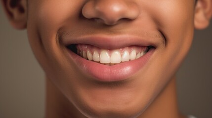 Fototapeta premium Smiling teen exhibits a perfect white-toothed grin in a well-lit studio.