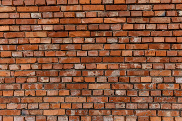 Red brick building scheduled for demolition, wrongly placed wall by the bricklayer