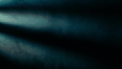 Fog and haze effect on a black background illuminated by spotlight beams and blue neon light. HDR...