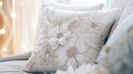 Closeup of a fluffy, designer throw pillow with intricate embroidery and embellishments, adding a touch of elegance to the bedding arrangement.