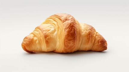  a close up of a croissant with a bite taken out of it's side on a white background.