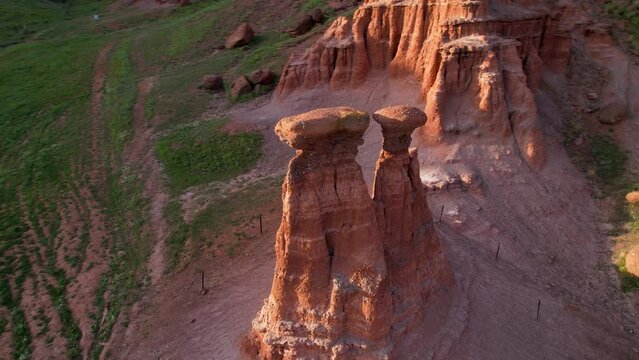 erzurum narman fairy chimneys green grass on red soil aerial view 4K