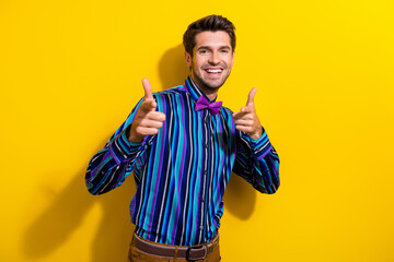 Portrait of positive cheerful guy dressed stylish shirt bow tie indicating at you smiling isolated on bright yellow color background