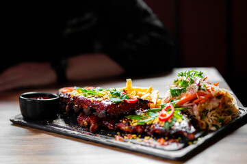 Pork ribs with french fries and coleslaw salad