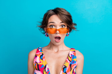Photo of funky excited lady wear print clothes dark glasses open mouth isolated blue color...