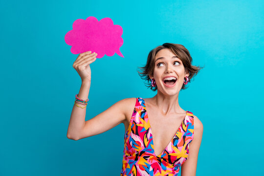 Photo of impressed woman with bob hairdo dressed colorful clothes look at mind cloud empty space isolated on blue color background