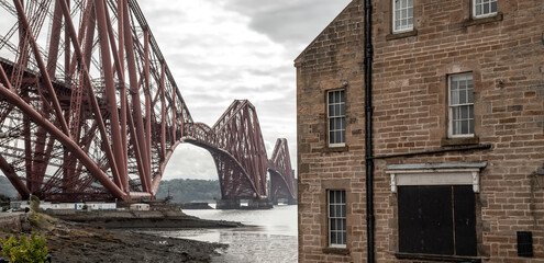 The Forth Bridge, view from North Queensferry town in Edinburgh neighborhood, Scotland industrial...