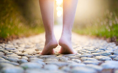 Woman walks with bare feet on a stony way, AI generated