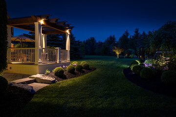 Beautiful custom built deck and pergola at night.