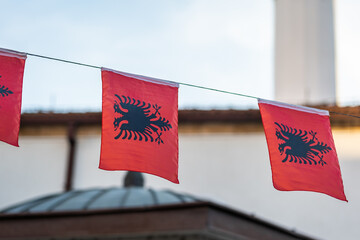 Albanian flag in city, national flag of Albania in street