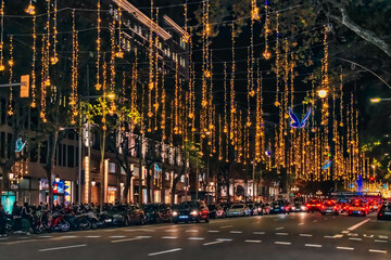 Barcelona, Spain - November 26, 2021: Christmas in Barcelona. Festive gold garlands with blue...