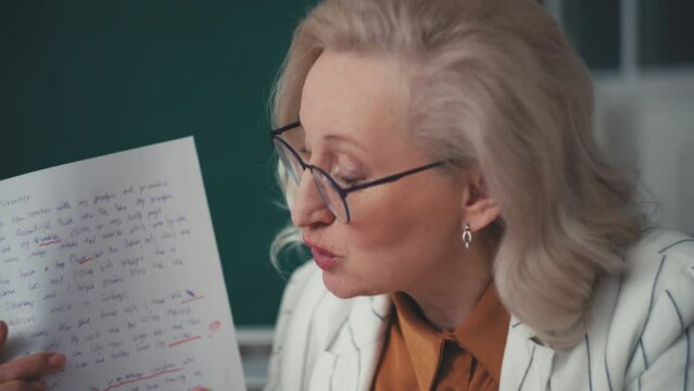 Disappointed teacher discussing student's badly written home assignment