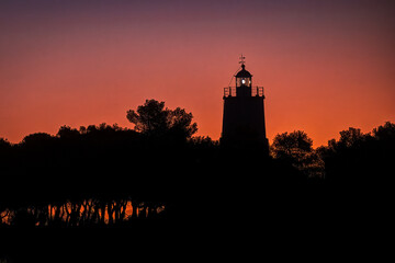 Beautiful lighthouse at dawn red hour, in Spetses island, Greece