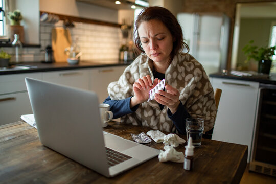Young Woman taking medication for her illness at home