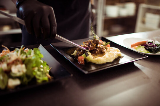 Gourmet Meal Plating by a Professional Chef in a Restaurant